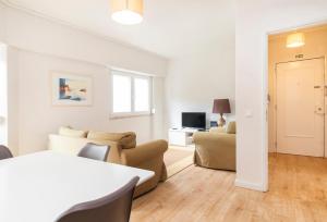 a living room with a couch and a table at PAREDE APARTMENT 2 in Cascais