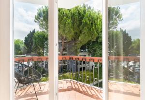 an open window with a view of a tree at PAREDE APARTMENT 2 in Cascais