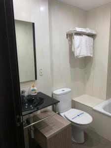 a bathroom with a toilet and a sink and a mirror at Estudio Arriola Suite in Málaga