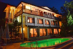 a large house with a swimming pool in front of it at Alesta Butik Otel in Şile