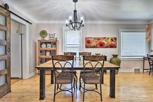 a dining room with a wooden table and chairs at Bright Mpls Getaway, 2 Mi to Minnehaha Falls! in Minneapolis