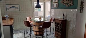 a kitchen with a table and chairs in a room at Villa Mas Sopes in Sant Pere Pescador