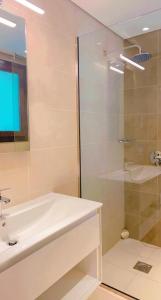 a bathroom with a tub and a sink and a shower at HAWANA villa 010 هوانا فيللا in Salalah