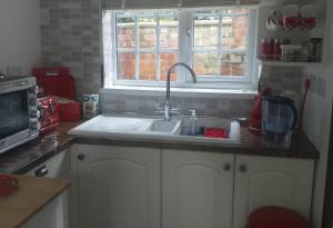 a kitchen with a sink and a window at The LITTLE HOUSE in HULL in Hull