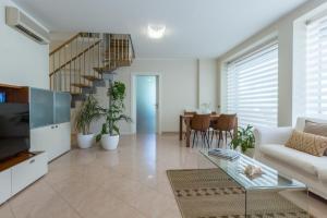 a living room with a couch and a staircase at Guesthouse Libeticus in Cagliari