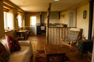 a living room with a couch and a table at Pathways, Beachwood Cottage in Bath