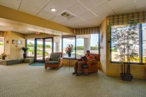 a man sitting in a chair in a waiting room at Casa Del Mar Beachfront II in Galveston