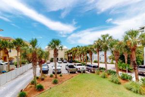 an aerial view of a parking lot with palm trees at Seaside Serenity - Beacons 9 in Santa Rosa Beach