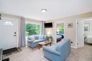 a living room with two chairs and a couch and a bed at Crystal Mountain Charm in Thompsonville