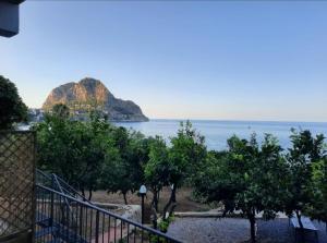 a view of the ocean with a mountain in the background at Capozafferano-Casa Carola in Santa Flavia
