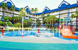a swimming pool with a pool table and chairs in front of it at Holiday Inn Resort Orlando Suites - Waterpark, an IHG Hotel in Orlando