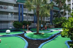 a green and white pool with a person standing in front of it at Holiday Inn Resort Orlando Suites - Waterpark, an IHG Hotel in Orlando