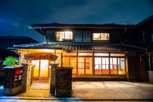 a house with a sign in front of it at Kominka Wagaya in Higashi-osaka