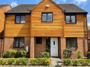 uma casa de madeira com uma porta branca em Lux Ulverston em Broughton