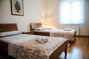 a hotel room with two beds with towels on them at Villa Miriam Family Apartment in Međugorje