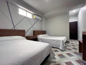 Cette chambre comprend 2 lits et une fenêtre. dans l'établissement Hotel Town Express, à Durango