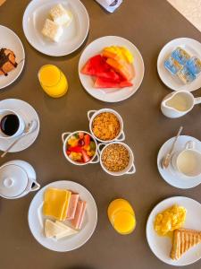 a table topped with plates of food and drinks at Hotel Nacional Rio de Janeiro in Rio de Janeiro