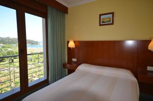 Tempat tidur dalam kamar di Hotel Maracaibo