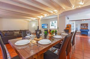 a dining room with a large wooden table and chairs at Casa Buena in Tías
