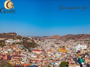 a view of a city with buildings on a hill at Hotel Chocolate Suites in Guanajuato