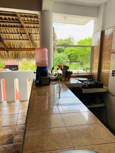 a kitchen with a counter and a large window at Casa Tacuba in Puerto Escondido +94 photos