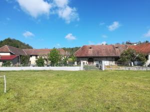 a house with a soccer field in front of it at Ferme les poneys de la Durme in Chélieu