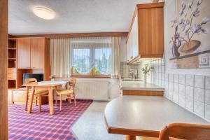 a kitchen with a table and chairs and a dining room at Pension Weirather in Imst