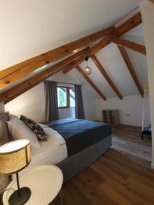 a bedroom with a large bed in a attic at River Houses Ljubljanica in Ljubljana
