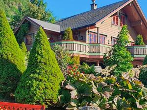 a large house with a garden in front of it at Four-Bedroom Holiday home in Hundeidvik in Hundeidvik