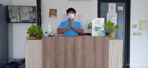 a man standing behind a counter wearing a mask at MAMA SYARIAH @ KUTAJAYA in Tangerang