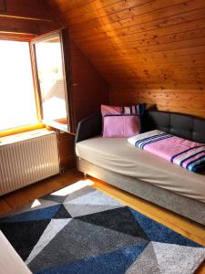 a small room with a bed in a wooden cabin at Termálfalu és Kemping Zalaegerszeg - Standard Plus in Zalaegerszeg