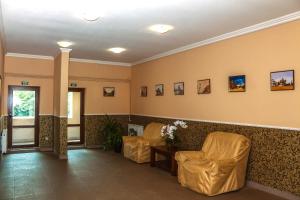 a waiting room with two chairs and a table at Fazenda in Sumy