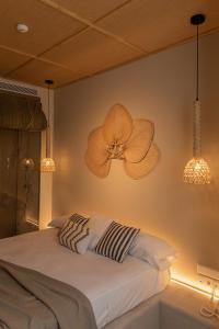 a bedroom with a bed with a flower on the wall at Hotel Boutique Sabbia Valencia in Valencia