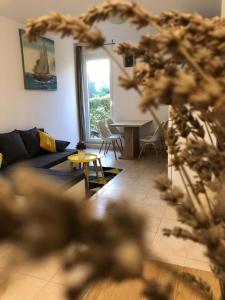 a living room with a couch and a table and chairs at Apartment Petra in Split