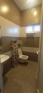 a bathroom with a toilet and a sink at Willow House Vagamon in Vagamon
