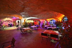 a restaurant in a cave with tables and chairs at Hotel Kotva - All Inclusive in Sunny Beach