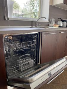 a dishwasher with dishes inside of it in a kitchen at Residence Hotel & Spa in Repino