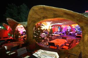 a restaurant with tables and chairs and lights at Hotel Kotva - All Inclusive in Sunny Beach +44 photos