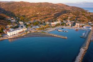 an aerial view of a town with a dock in the water at Tylos Beach Hotel in Kato Pyrgos