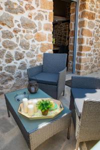 a table with a tray of candles and plants on it at ADRIAN'S LUXURY APARTMENTS 2 in Dhrepanon