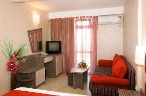 a hotel room with a bed and a television at Hotel Kotva - All Inclusive in Sunny Beach