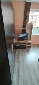 a living room with a couch and a window at Къща, стаи за гости Мери in Chernomorets
