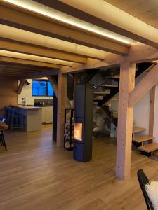a fireplace in the middle of a room with wooden beams at Chalet nature et design in Servoz