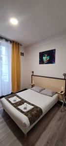 1 dormitorio con 1 cama grande y 2 bandejas. en Hôtel Renova, en Nantes