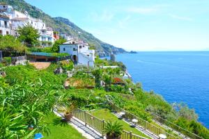 a town on a hill next to the ocean at Hotel Costa Diva in Praiano