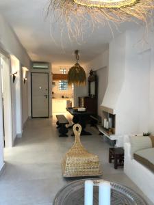 a living room with a couch and a table at Garden Oasis by the Sea - Pool & Parking in Agioi Theodoroi