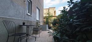 a patio with a table and chairs and plants at Number 28 Boutique Apartment in Zagreb