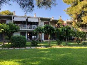 an exterior view of a building with trees at Garden Oasis by the Sea - Pool & Parking in Agioi Theodoroi