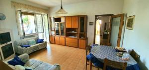 a living room with a table and a couch at Villa nella collina Francavillese in Francavilla al Mare