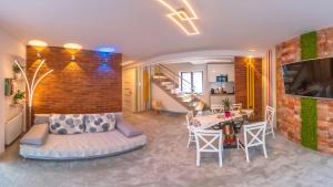 a living room with a couch and a brick wall at Apartament Huzar in Krynica Zdrój